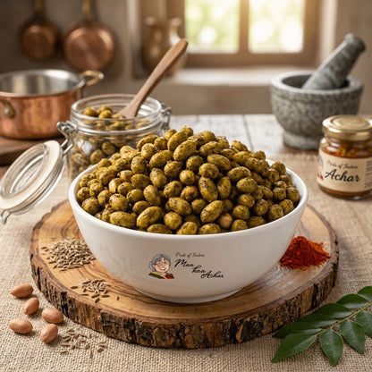 Maa Kaa Achar spicy peanuts in bowl on wood slab with pickle jar and copper cookware